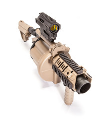 Tan grenade launcher, spotlighting the barrel while shot in studio.