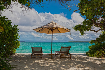 parasol and chairs on the beach of hanimaadhoo (maldives)