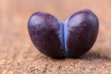 heart shape plum on dark wood