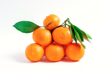 Tangerines or clementines with green leaf isolated on white background.