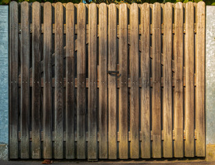 A wooden gate with handle