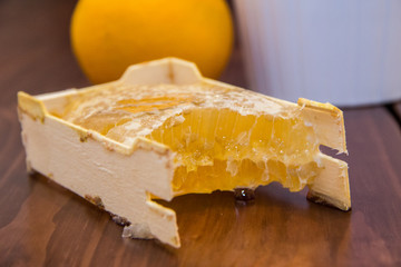 honey in honeycomb on wooden background