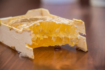 honey in honeycomb on wooden background