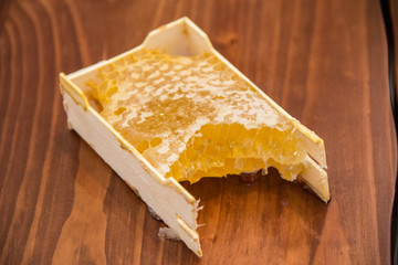 honey in honeycomb on wooden background