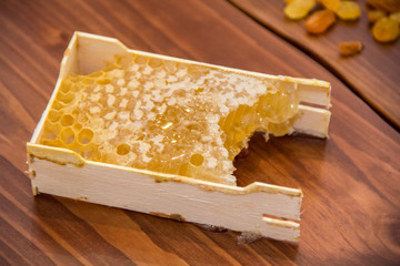 honey in honeycomb on wooden background