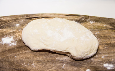 dough with flour on a wooden background