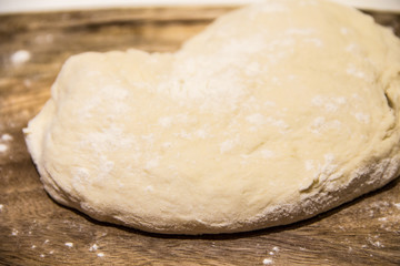 dough with flour on a wooden background