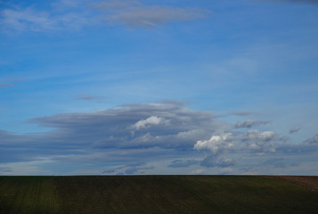 Fototapeta na wymiar Landscape cloudy sky and agriculture field