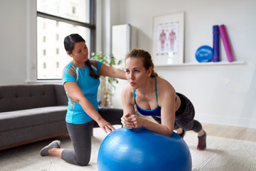 Chinese woman personal trainer during a workout session with an