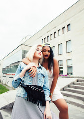 Two teenage girls infront of university building smiling, having fun traveling europe, lifestyle people concept closeup