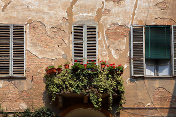 Fototapeta na wymiar ancient windows and balcony with flowers