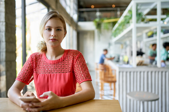 Lifestyle portrait of confident young female professional blonde