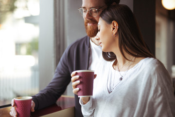 Young couple drinking coffee in cafe