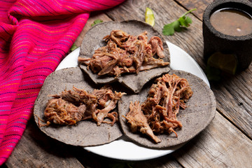 Fototapeta na wymiar Mexican slow cooked lamb tacos also called barbacoa on wooden background