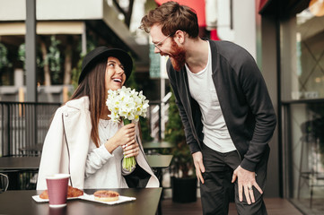 Happy woman receiving bouquet from boyfriend