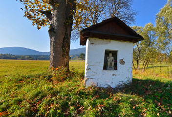 Old small chapel of Pensive Christ  in autumn sunny day, Low Beskids (Beskid Niski), Poland. - obrazy, fototapety, plakaty