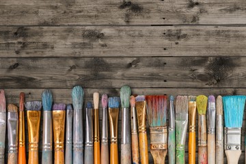 Row of artist paint brushes  on background