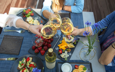 Dinner with wine and fruits on wooden table, upper view