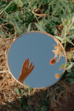 Close up of woman's hand reflecting in mirror