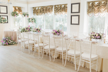 Floral wedding decoration. Wedding table setting decorated with fresh flowers. Wedding floristry. Bouquet with roses, eustoma and eucalyptus leaves.