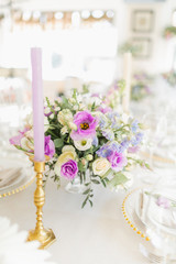 Floral wedding decoration. Wedding table setting decorated with fresh flowers. Wedding floristry. Bouquet with roses, eustoma and eucalyptus leaves.