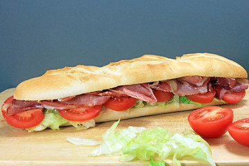 Long Crusty Fresh Baguette Filled With Bacon Lettuce And Tomato.