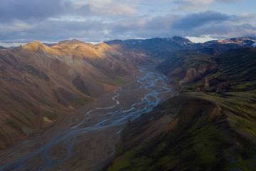Iceland in september 2019. Great Valley Park Landmannalaugar, surrounded by mountains of rhyolite and unmelted snow. In the valley built large camp. The concept of world tours.