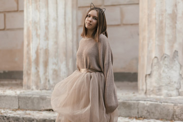 Teen girl in brown tulle skirt and autumn sweater