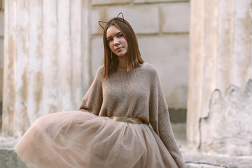 Teen girl in brown tulle skirt and autumn sweater