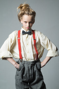 Cool and confident. retro fashion model. vintage charleston party. teen girl in retro male suit. suspender and bow tie. old fashioned child. vintage english style. jazz step fashion