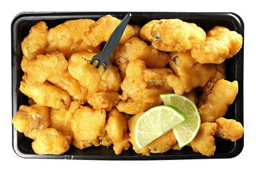 Kibbeling in a plastic tray isolated on white background. Kibbeling is a Dutch snack consisting of battered chunks of fish. It is a very popular dish in the Netherlands.