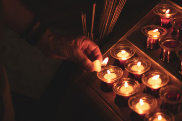 lighting candles in church