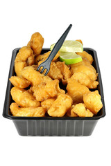 Kibbeling in a plastic tray isolated on white background. Kibbeling is a Dutch snack consisting of battered chunks of fish. It is a very popular dish in the Netherlands.