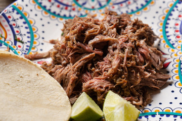 Mexican slow cooked lamb also called barbacoa on wooden background