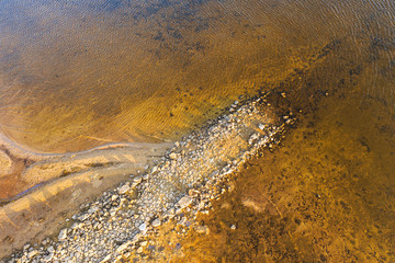 Aerial view from drone top view. Aerial view over river. Water with stones. Beautiful fall nature travel or minimalistic background.