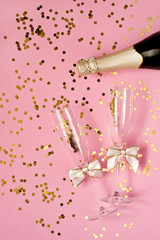 Celebration background - top view of two crystal champagne glasses and bottle