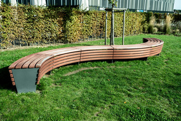 A modern bench  in a city park on a sunny day