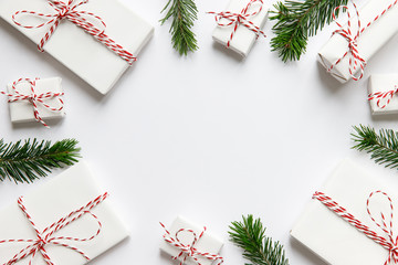 New Year composition. Christmas background with white wrapped gifts boxes with ribbon, fir branches...