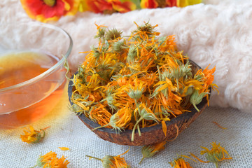 Calendula dried flowers in coconut bowl, For herbal tea, Medicine, Background