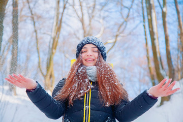 Fototapeta na wymiar Moments of happiness and joy. Beautiful young girl rejoices the first snowfall.