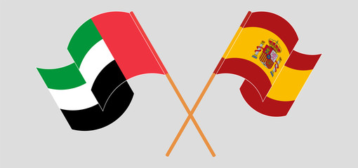 Crossed and waving flags of the United Arab Emirates and Spain