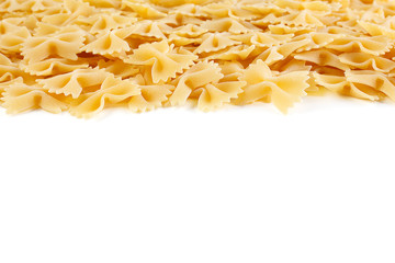 A variety of types and shapes of Italian pasta. Dry pasta bows farfalle .  Heap of bow tie macaroni...