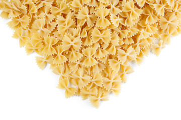 Obraz premium A variety of types and shapes of Italian pasta. Dry pasta bows farfalle . Heap of bow tie macaroni isolated on white background.