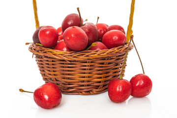 Cherry in basket isolated on white background