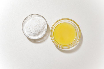 wheat flour and butter in a glass bowls on a white background