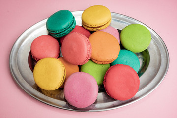 Dessert cake macaron or macaroon on pink background