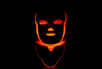 Color therapy mask glowing red dark background