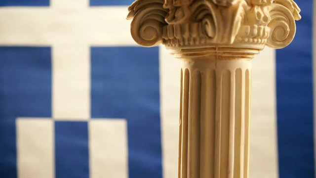 Single ancient column rotating on blue white greek flag background