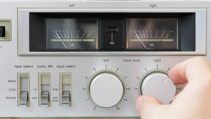 Detail of hand turn old radio button, fix the volume of music