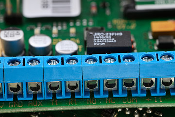 Blue terminal block on printed circuit board.
